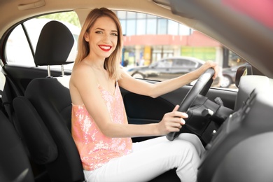 Young woman on driver's seat of car