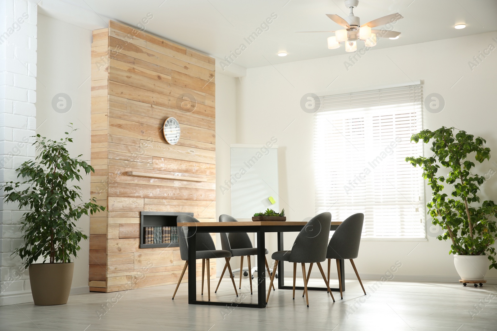 Photo of Modern meeting room interior with large table and chairs