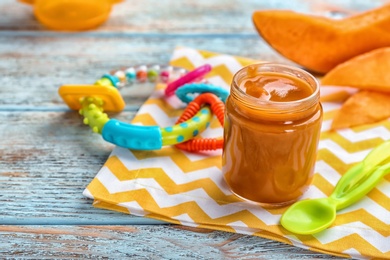 Jar with healthy baby food on table