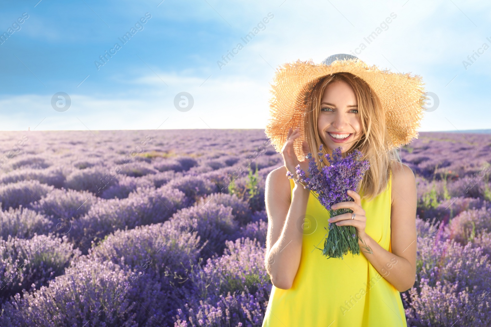 Photo of Young woman with bouquet in lavender field