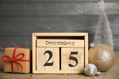 Block calendar and festive decor on wooden table