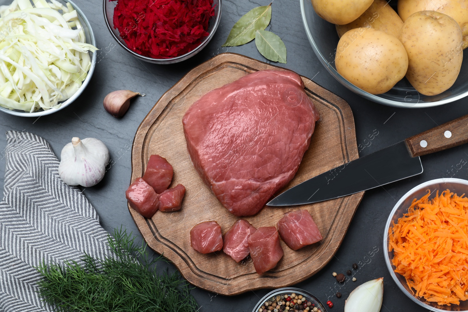 Photo of Fresh ingredients for borscht on black table, flat lay