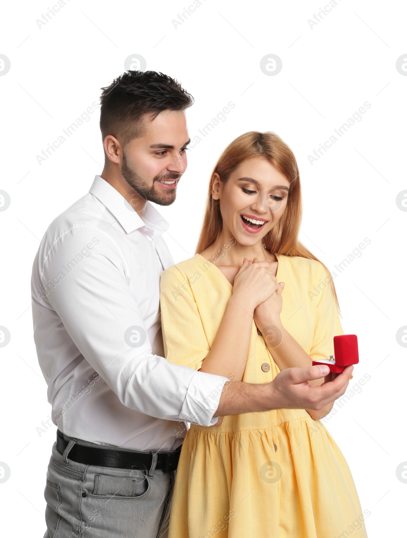 Photo of Man with engagement ring making marriage proposal to girlfriend on white background