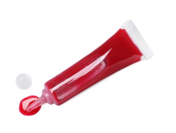 Photo of Tube with red food coloring isolated on white, top view