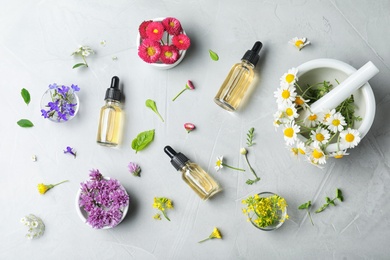 Photo of Flat lay composition with bottles of essential oils on grey background