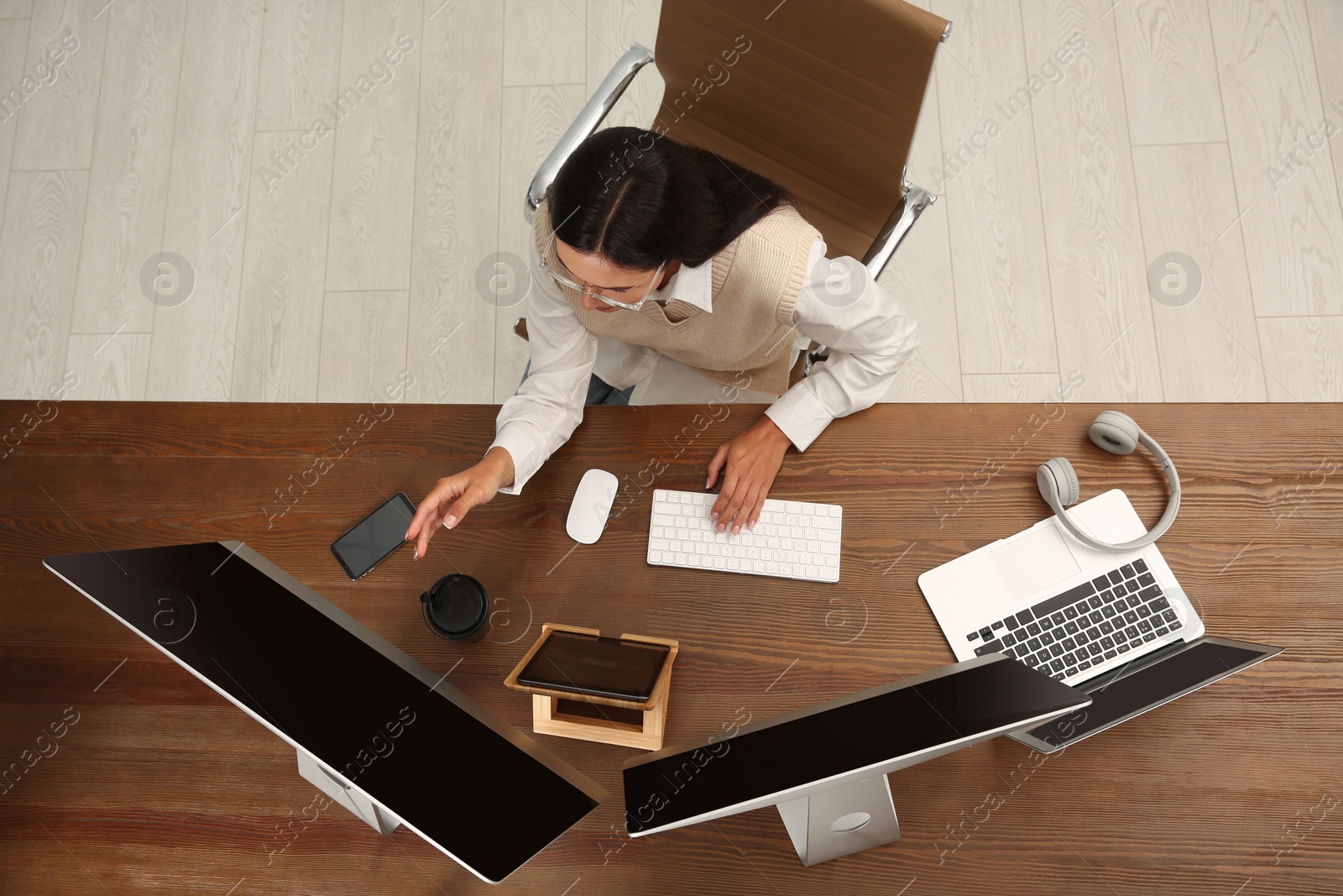 Photo of Programmer working at desk in office, top view