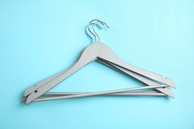 Photo of Flat lay composition with empty hangers on color background