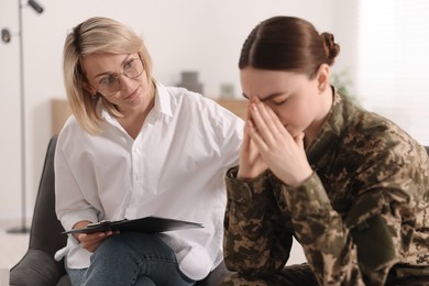 Photo of Psychotherapist working with military woman in office