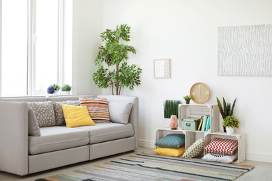 Photo of Interior of modern living room with pillows on sofa