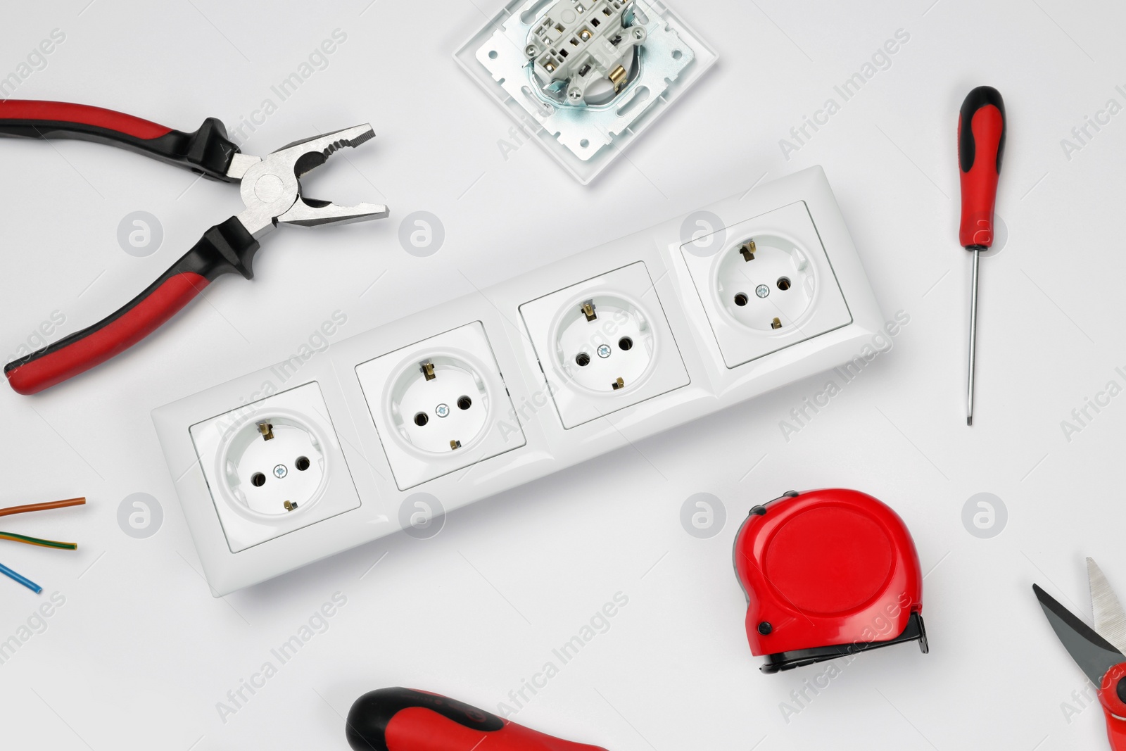 Photo of Set of sockets and electrician's tools on white background, top view