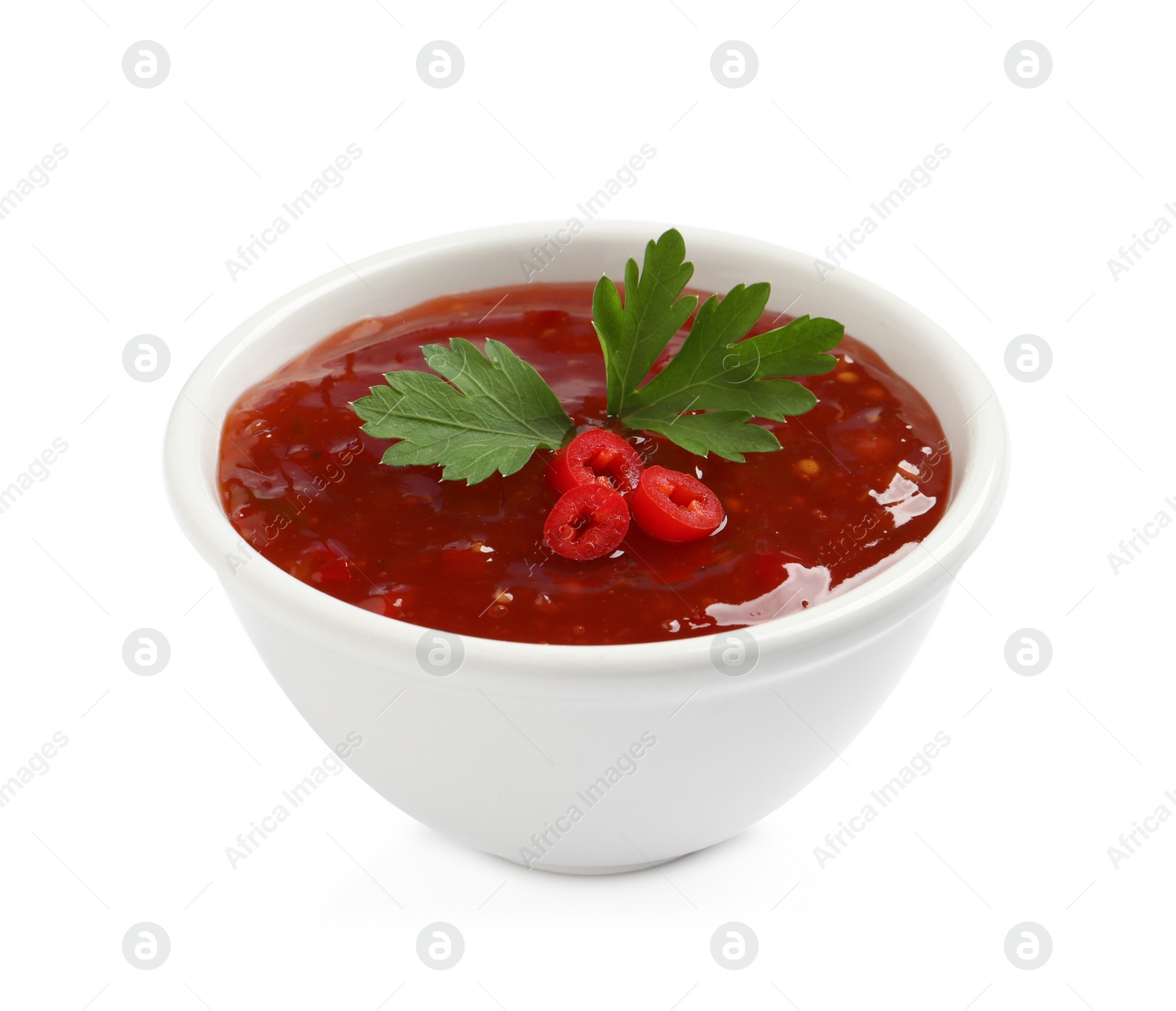 Photo of Spicy chili sauce with parsley on white background