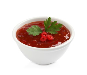 Photo of Spicy chili sauce with parsley on white background