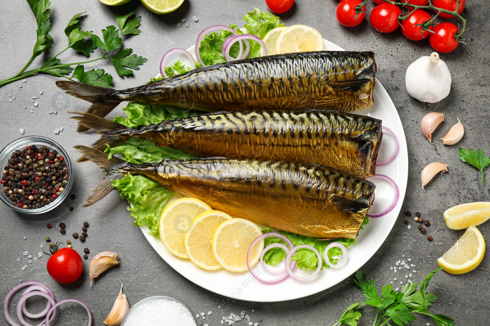 Photo of Flat lay composition with tasty smoked fish on grey table