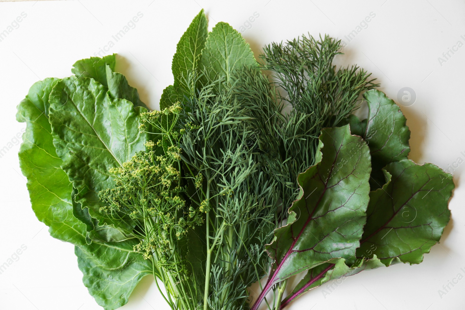 Photo of Different herbs on white wooden table, flat lay