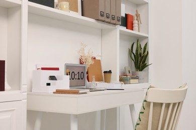 Photo of Cozy workspace with laptop on wooden desk at home