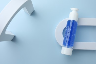 Cosmetic product on light blue background, top view
