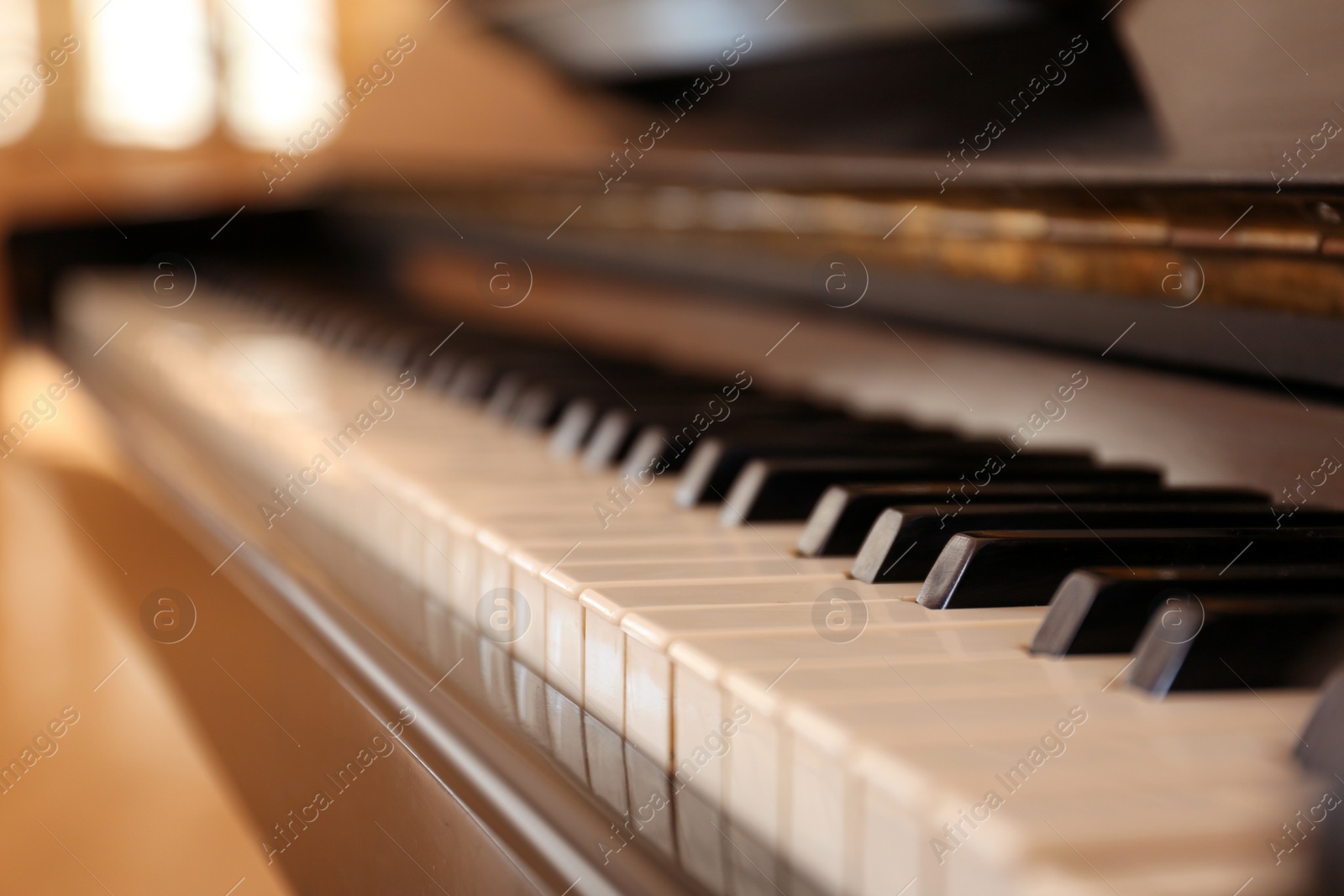 Photo of Black and white piano keys indoors, closeup