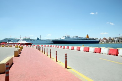 Picturesque view of port with road and modern boats on sunny day