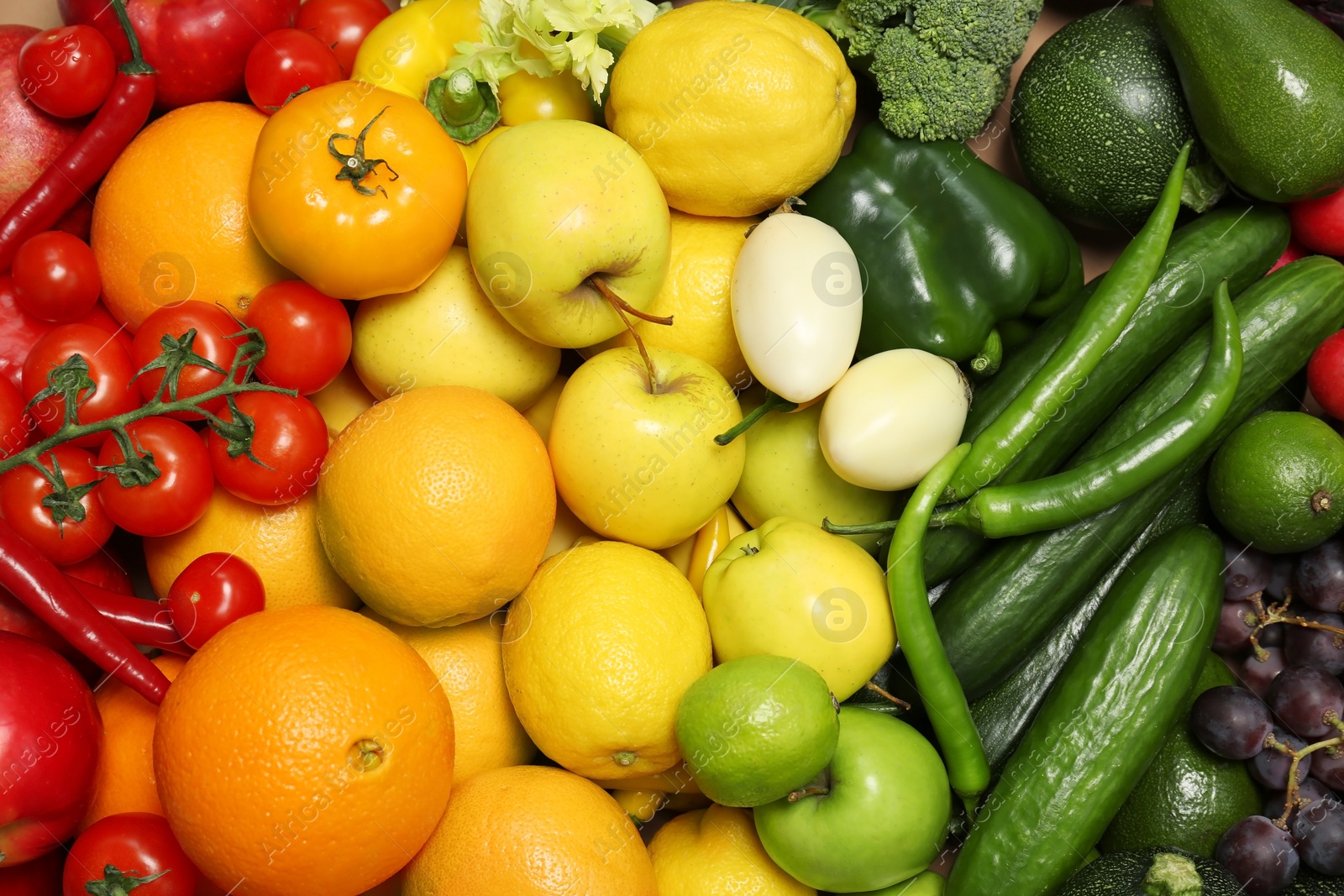 Photo of Rainbow collection of ripe fruits and vegetables as background, top view