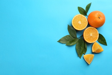 Delicious oranges on light blue background, flat lay. Space for text