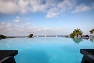 Photo of Beautiful landscape with blue sky and infinity pool at resort