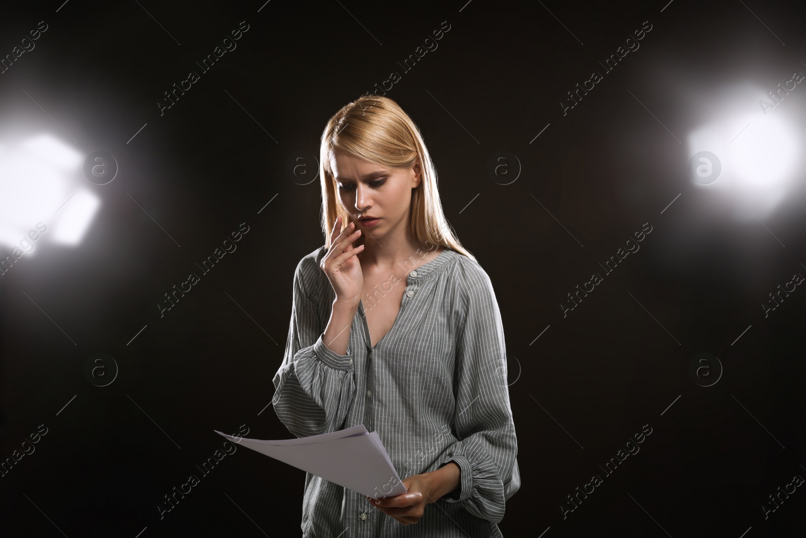 Photo of Professional actress reading her script during rehearsal in theatre