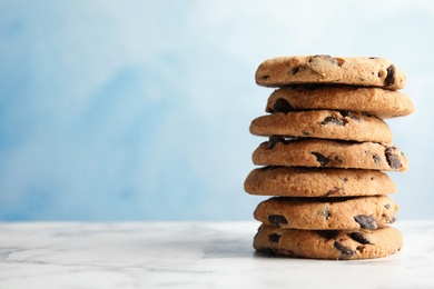 Photo of Stack of tasty chocolate chip cookies on table. Space for text