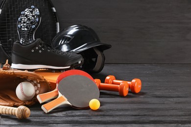 Photo of Many different sports equipment on dark grey wooden table