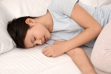 Photo of Cute little girl sleeping in bed at home