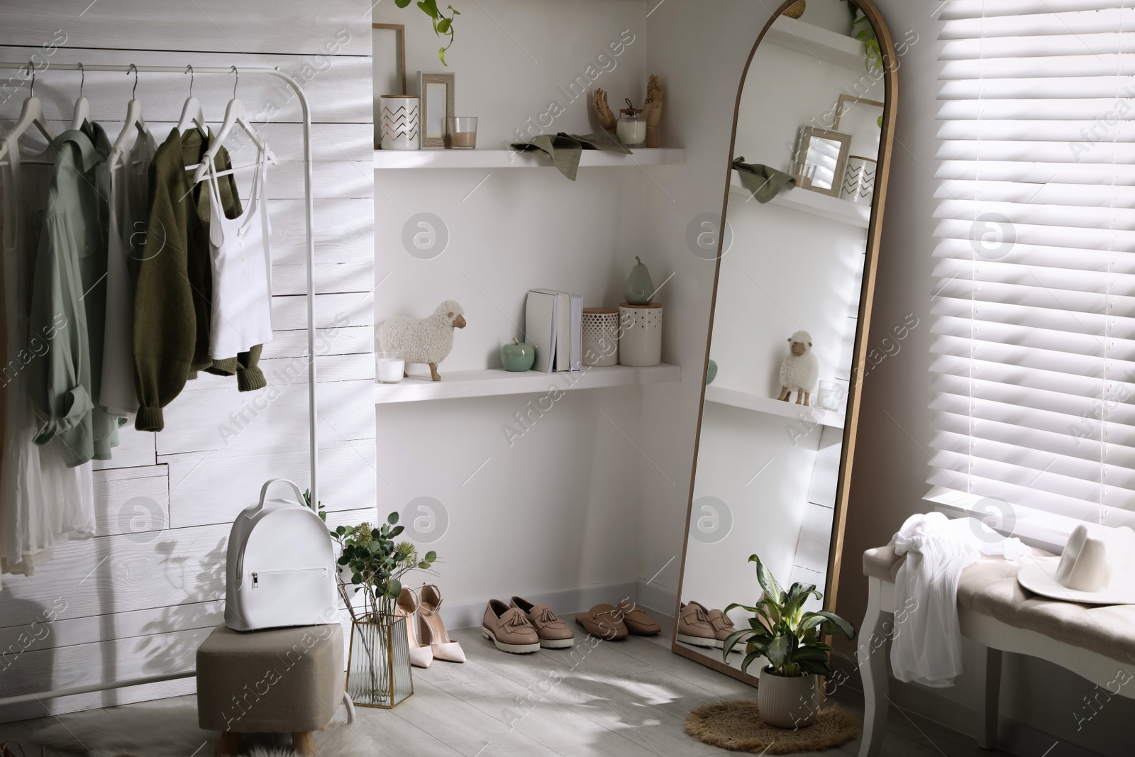 Photo of Rack with different stylish clothes, shoes and decorative elements in dressing room. Interior design