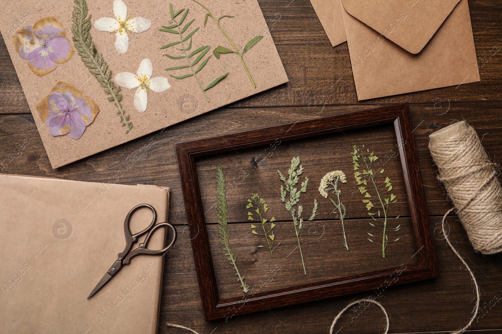 Photo of Flat lay composition with dried flowers and plants on wooden table