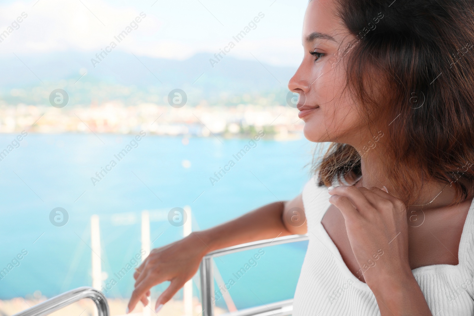 Photo of Portrait of happy young woman on Ferris wheel near sea