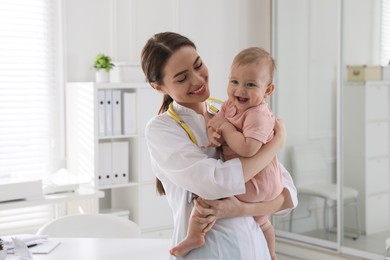 Young pediatrician with cute little baby in clinic