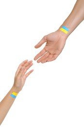 Photo of Man and woman with painted Ukrainian flags on their hands against white background, closeup