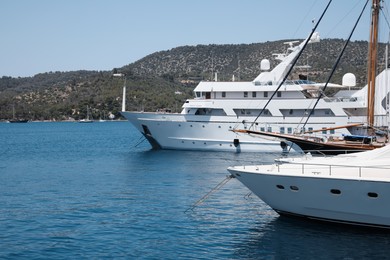 Photo of Beautiful view of different boats in sea near shore on sunny day