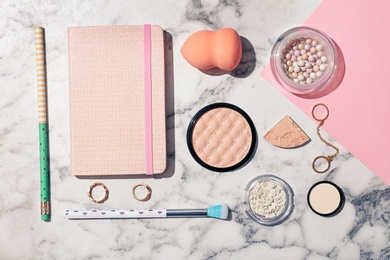 Photo of Flat lay composition with cosmetic products and notebook on light background