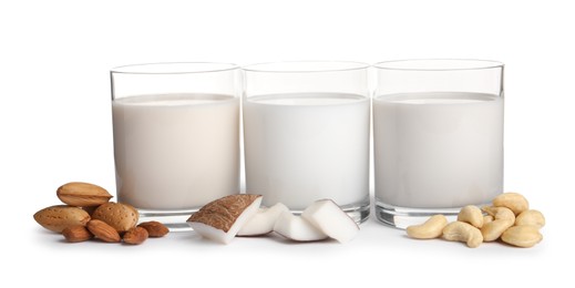 Photo of Vegan milk and different nuts on white background