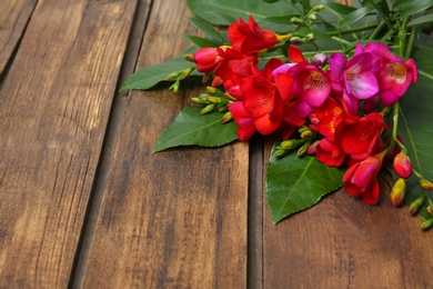 Beautiful freesia bouquet on wooden background