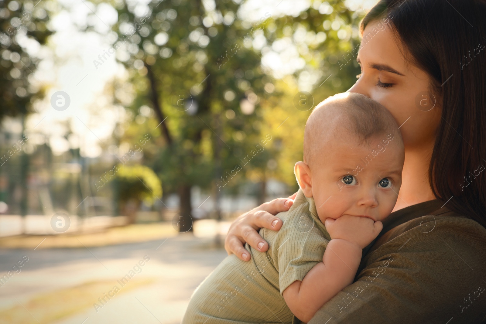 Photo of Young mother with her cute baby in park on sunny day