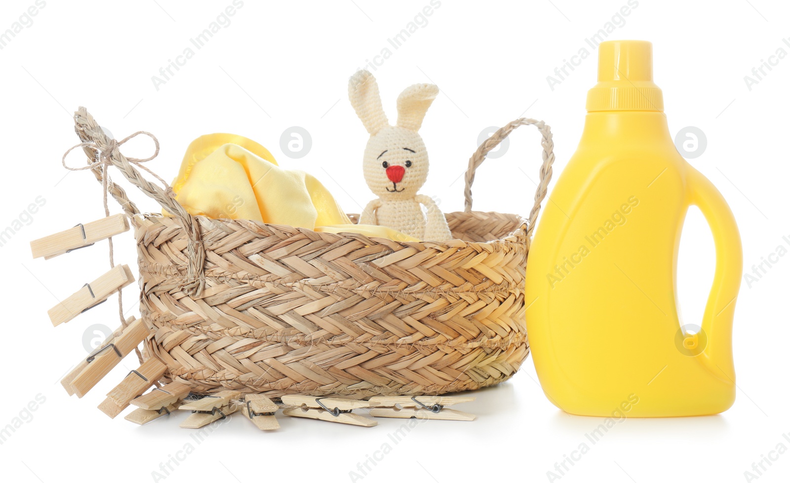 Photo of Detergent, toy and children's clothes on white background