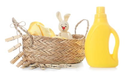 Photo of Detergent, toy and children's clothes on white background