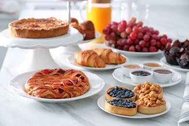 Variety of snacks on white marble table in buffet style