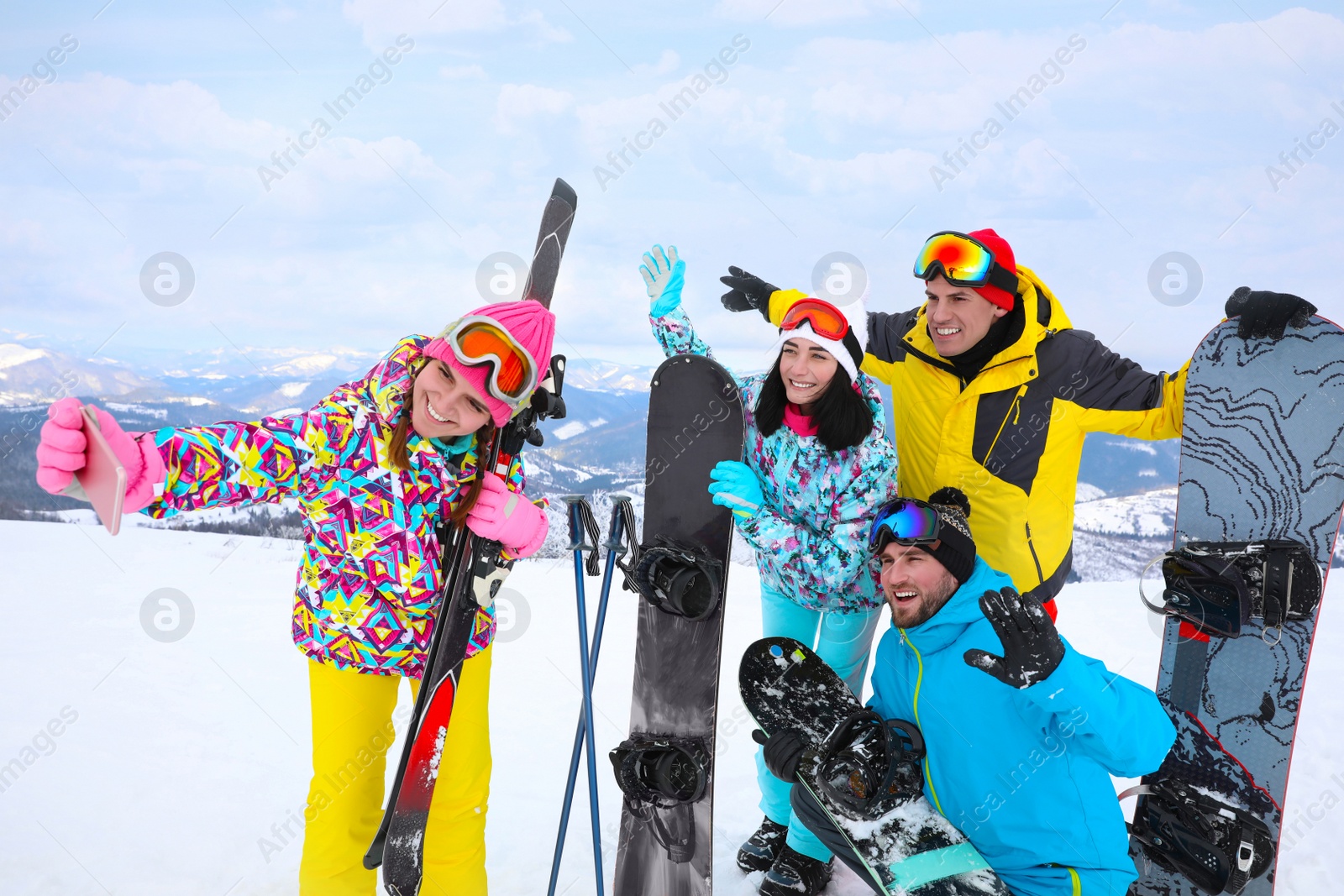 Photo of Group of friends taking selfie at mountain resort. Winter vacation