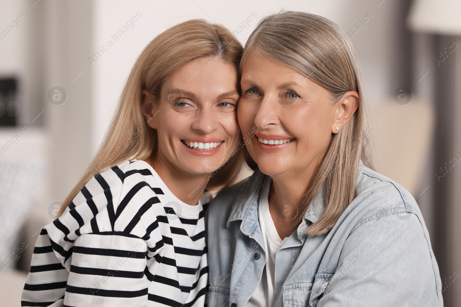 Photo of Happy daughter and her mature mother indoors