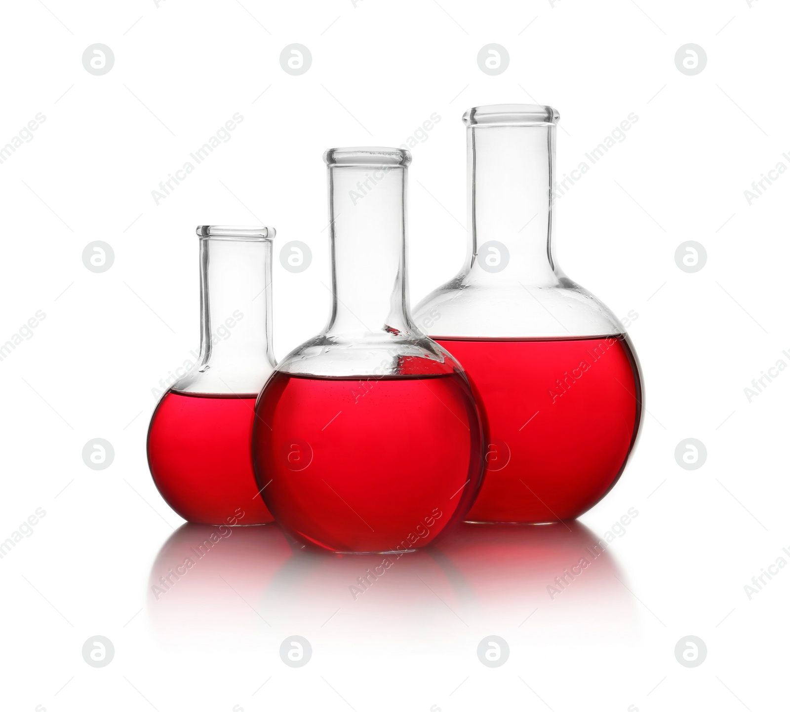 Photo of Florence flasks with red liquid on white background. Laboratory glassware