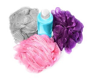 Photo of New shower puffs and bottle of cosmetic product on white background
