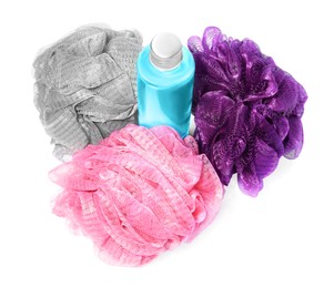 New shower puffs and bottle of cosmetic product on white background