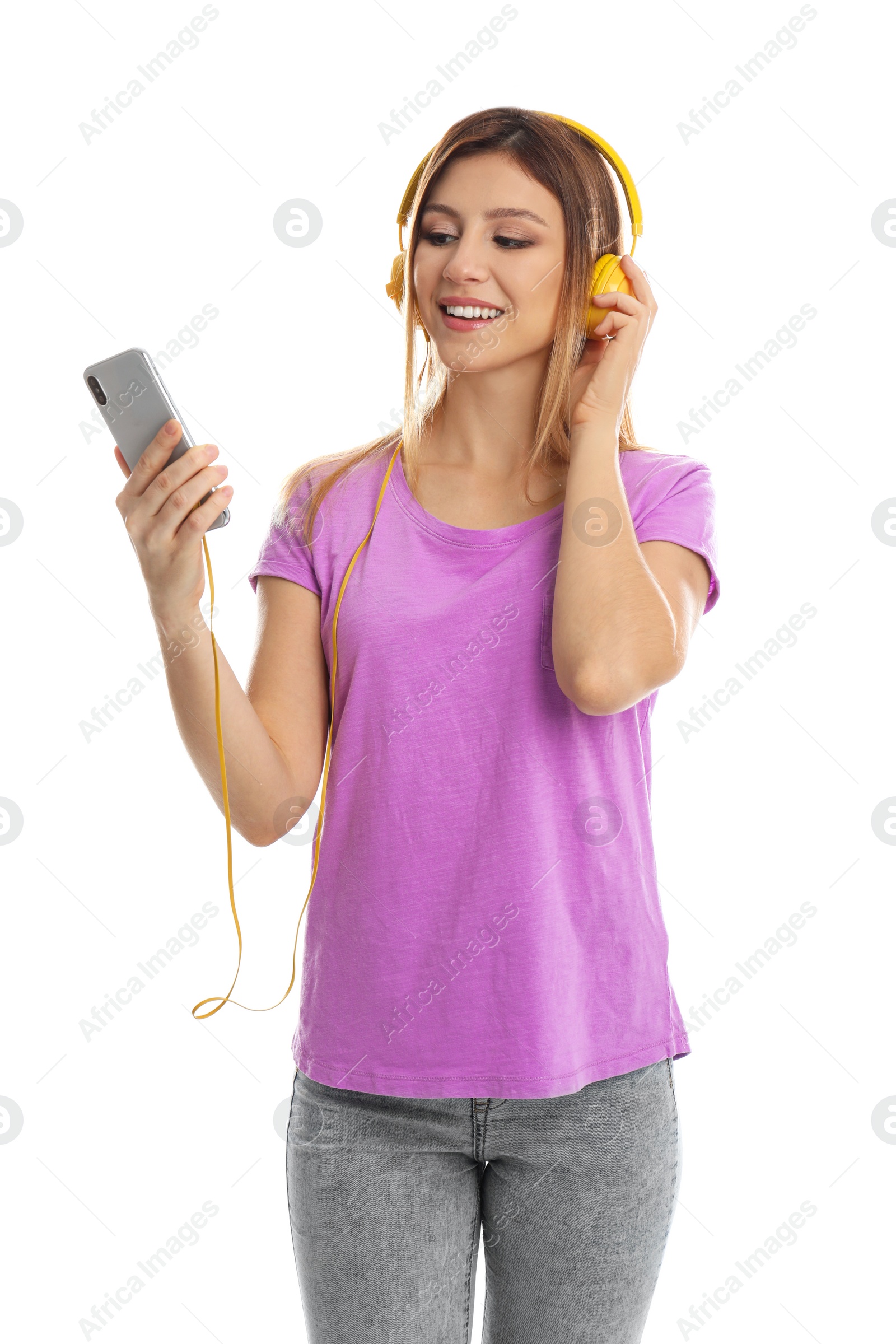 Photo of Young woman listening to music with headphones and mobile phone on white background