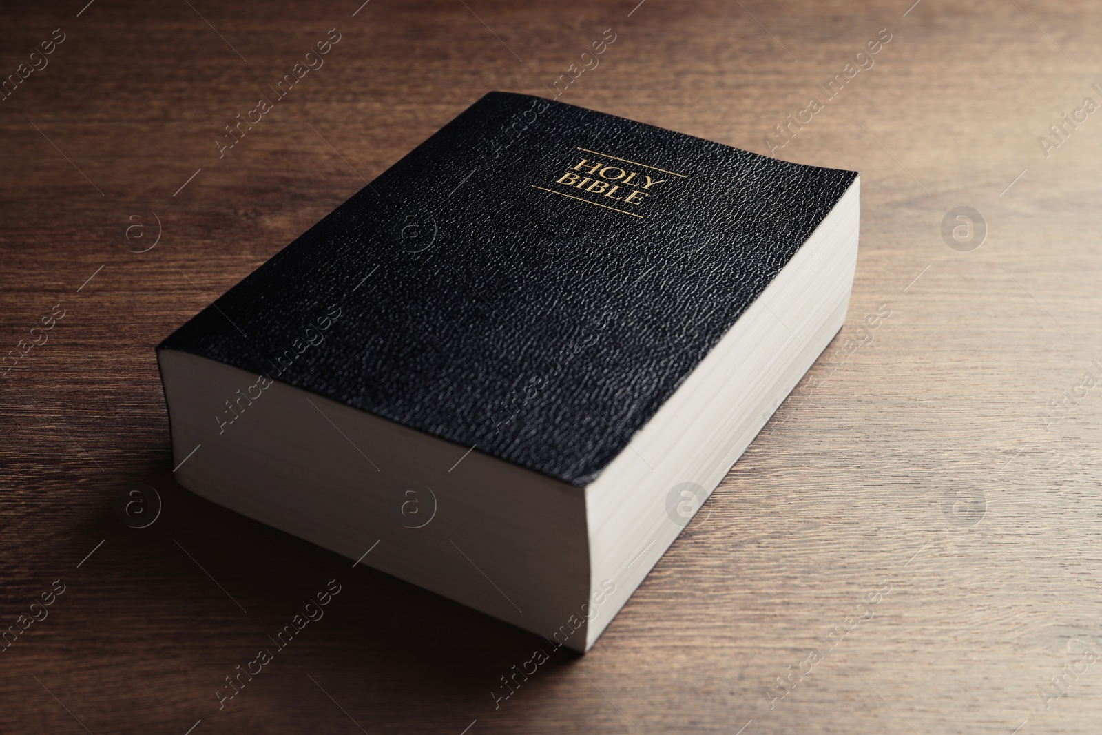 Photo of Holy Bible on wooden table, closeup. Religious book