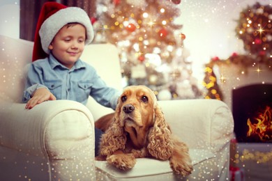Image of Cute little boy with English Cocker Spaniel in room decorated for Christmas. Magical festive atmosphere
